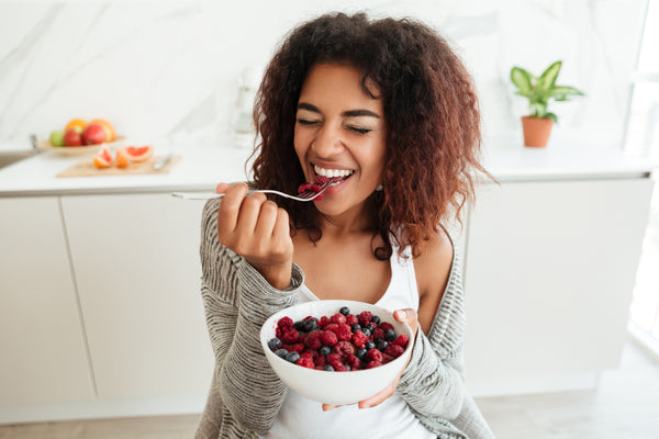 Woman Eating Fruit for Probiotics | LoveBug Probiotic Supplements